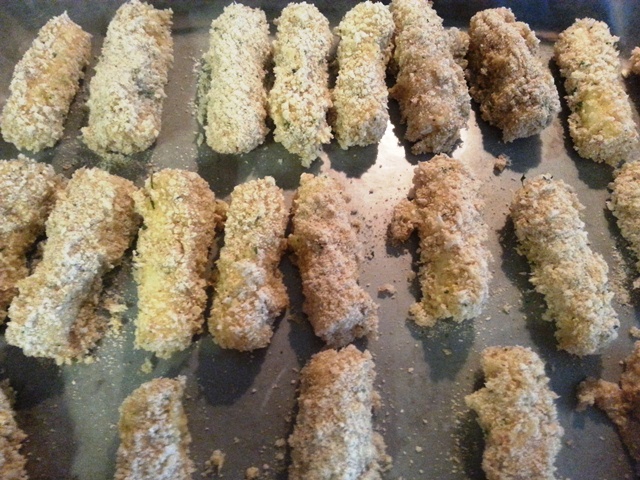 Cheese sticks breaded and placed on cookie sheet to freeze before cookin